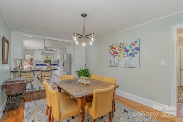 dining room featuring ornamental molding, hardwood / wood-style floors, and ceiling fan