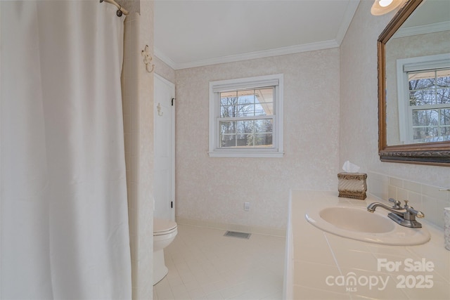 bathroom with crown molding, tile patterned floors, toilet, and a wealth of natural light