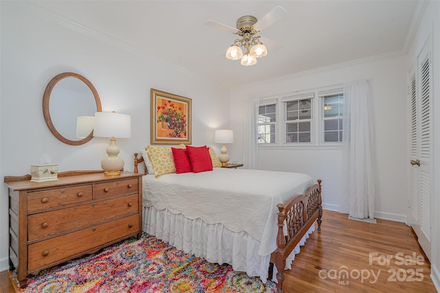 bedroom with crown molding, light wood-type flooring, and a closet