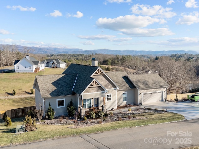 view of front facade with a garage and a mountain view