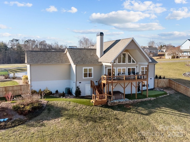 back of house with cooling unit, a yard, a hot tub, and a deck