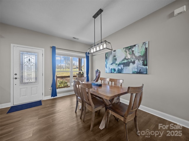 dining area with dark hardwood / wood-style flooring