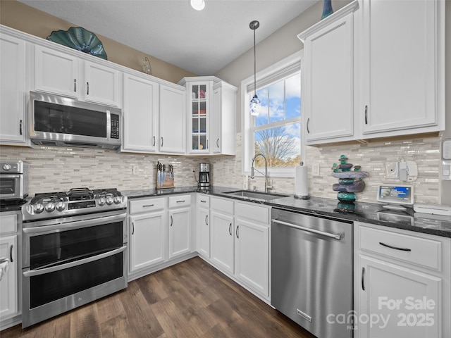 kitchen featuring white cabinetry, appliances with stainless steel finishes, and sink