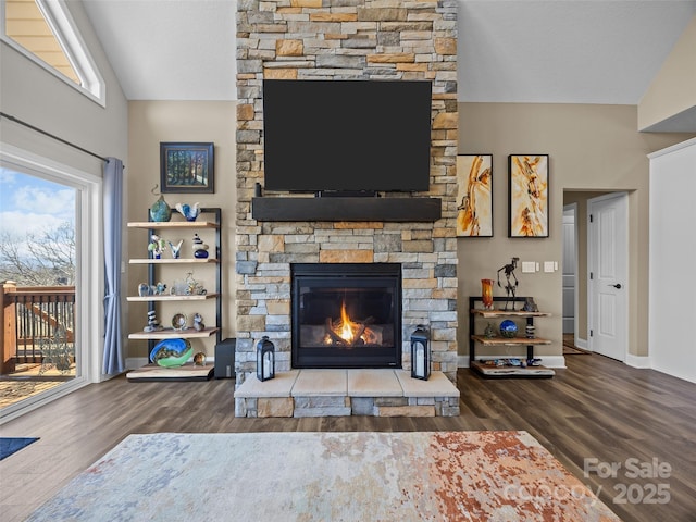 unfurnished living room featuring dark hardwood / wood-style flooring, lofted ceiling, and a fireplace