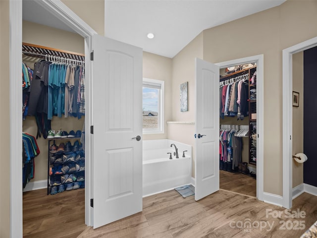 bathroom featuring a bathtub and hardwood / wood-style flooring