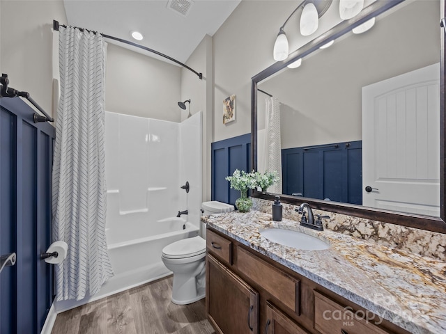 full bathroom with vanity, hardwood / wood-style flooring, toilet, and shower / bath combo with shower curtain