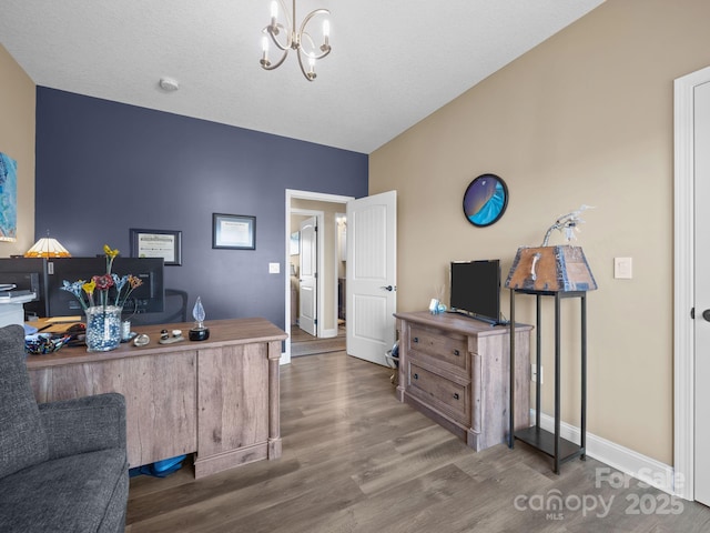 home office featuring dark wood-type flooring and a chandelier