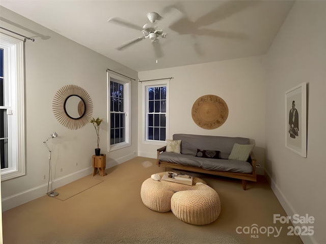 sitting room with ceiling fan, carpet floors, and baseboards