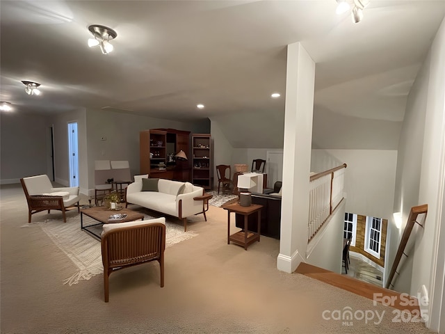 carpeted living room with lofted ceiling