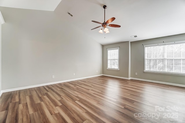 empty room featuring ceiling fan, hardwood / wood-style floors, and vaulted ceiling