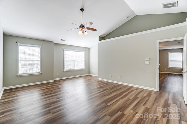 unfurnished room featuring ceiling fan, dark hardwood / wood-style flooring, high vaulted ceiling, and a healthy amount of sunlight