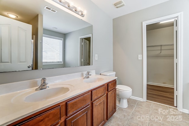 bathroom featuring tile patterned flooring, vanity, and toilet