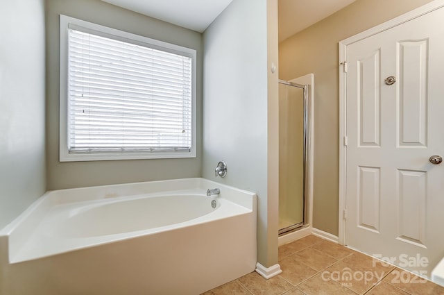 bathroom with tile patterned floors and separate shower and tub