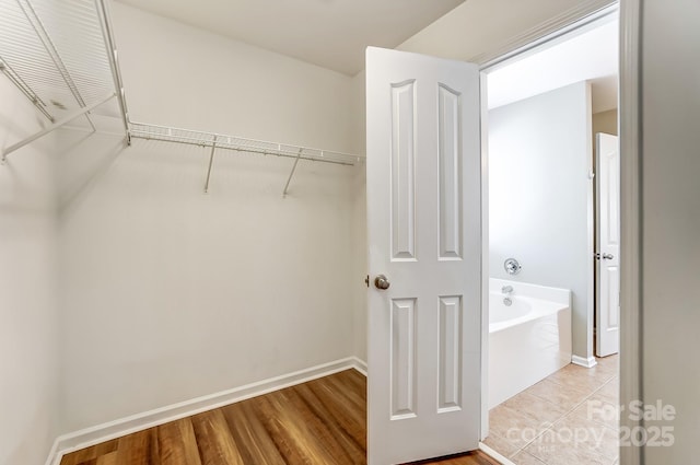 walk in closet featuring light tile patterned flooring