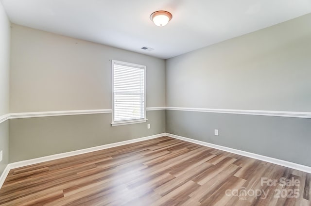 unfurnished room featuring light hardwood / wood-style flooring