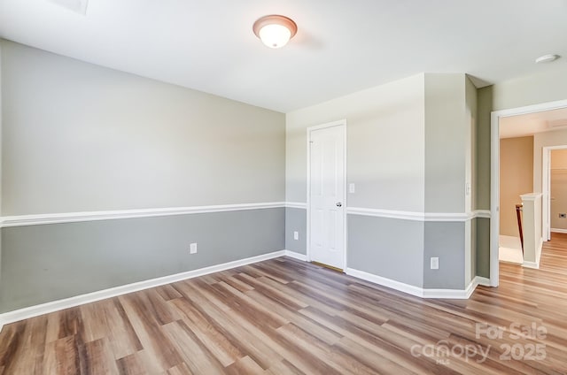 spare room with light hardwood / wood-style flooring