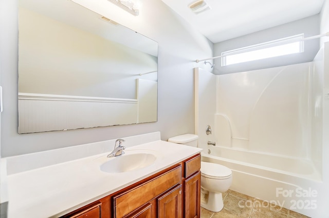 full bathroom featuring tile patterned floors, vanity, toilet, and washtub / shower combination