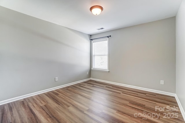 spare room featuring hardwood / wood-style flooring