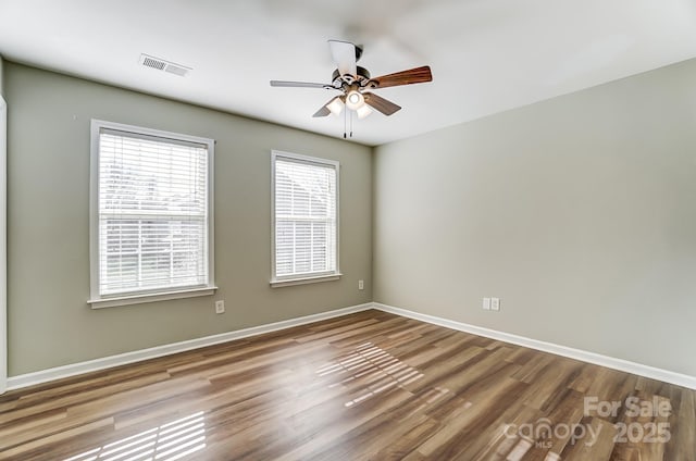 empty room with ceiling fan and wood-type flooring