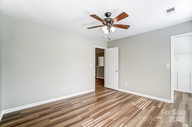 spare room with hardwood / wood-style floors and ceiling fan