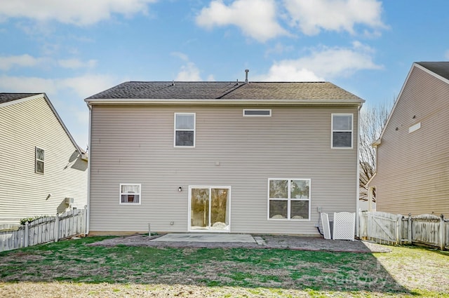 rear view of house featuring a lawn and a patio