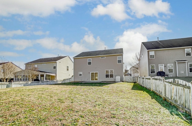 rear view of property with a yard