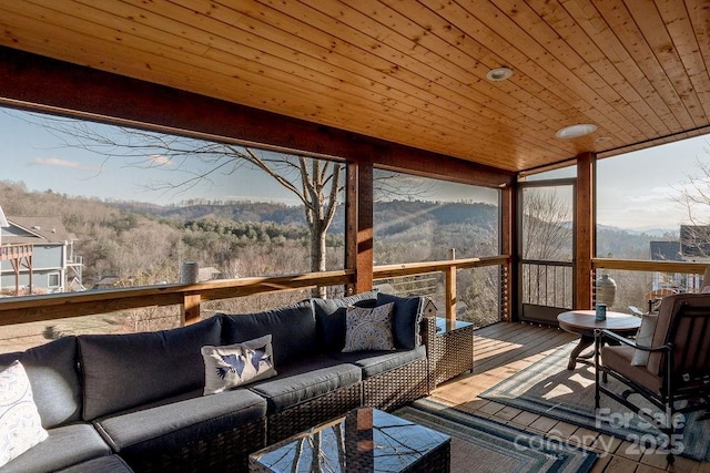 deck featuring an outdoor living space and a mountain view