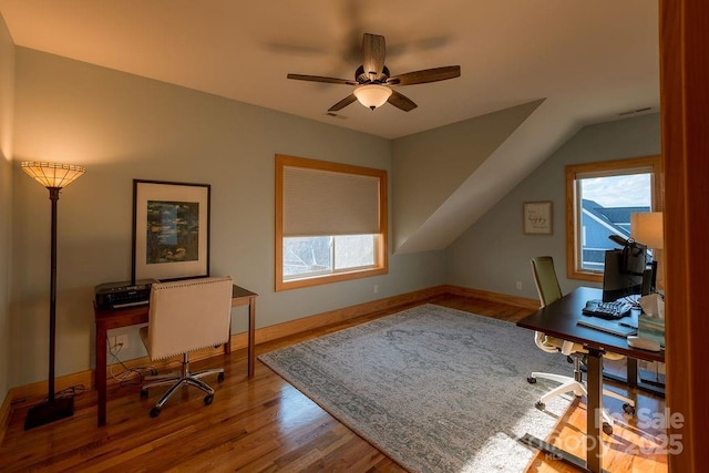 office area with ceiling fan, hardwood / wood-style floors, and vaulted ceiling