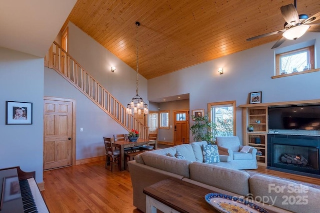 living room featuring high vaulted ceiling, wooden ceiling, light hardwood / wood-style flooring, and ceiling fan with notable chandelier