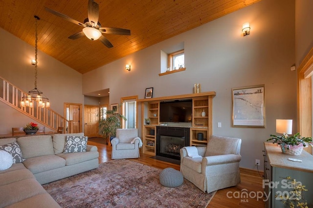 living room with high vaulted ceiling, hardwood / wood-style floors, wood ceiling, and ceiling fan with notable chandelier