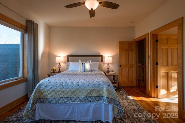 bedroom with ceiling fan and hardwood / wood-style flooring