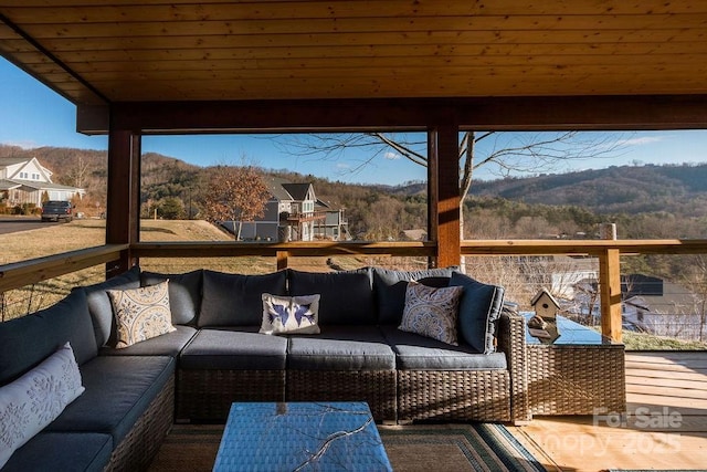 sunroom / solarium featuring a mountain view and wooden ceiling