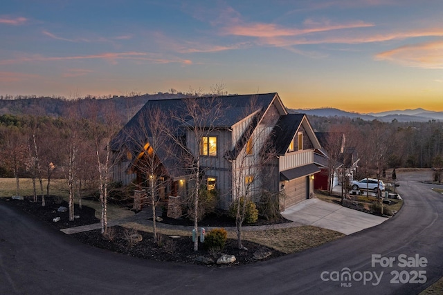 view of front of home with a mountain view and a garage