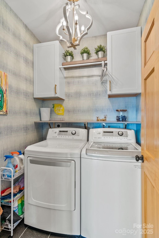 laundry room with cabinets, separate washer and dryer, and a notable chandelier