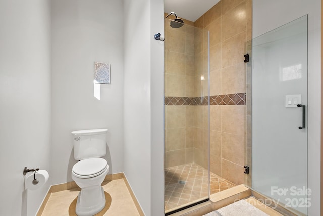 bathroom featuring tile patterned floors, toilet, and walk in shower