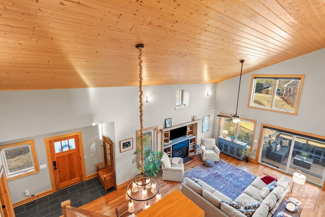 living room featuring plenty of natural light, dark wood-type flooring, wooden ceiling, and high vaulted ceiling