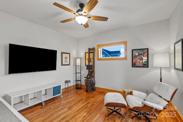 living area featuring light hardwood / wood-style flooring and ceiling fan