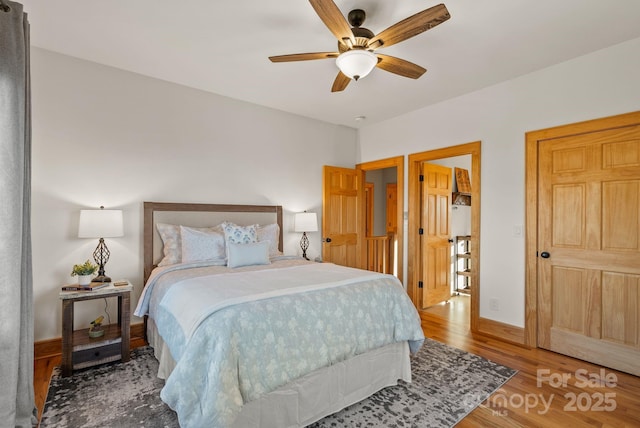 bedroom featuring hardwood / wood-style floors and ceiling fan