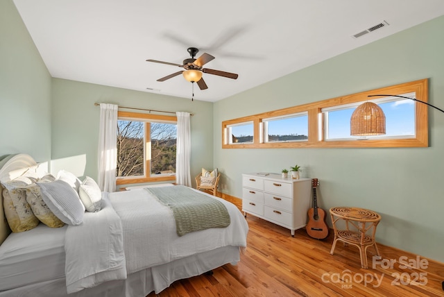 bedroom with ceiling fan and light hardwood / wood-style floors