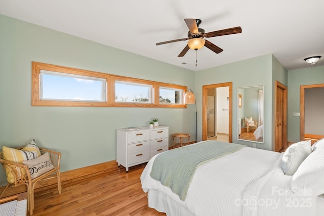 bedroom featuring multiple windows, ceiling fan, and light hardwood / wood-style flooring