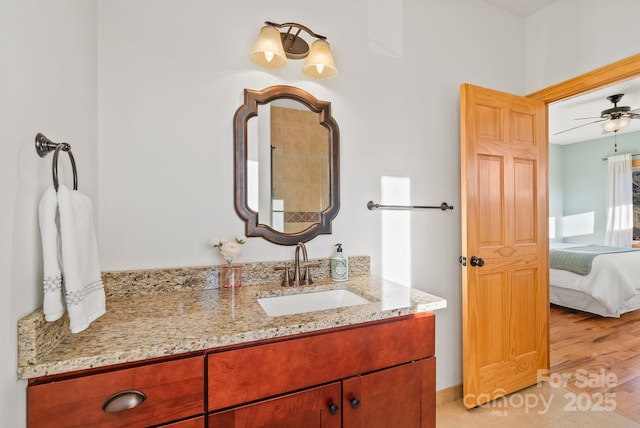 bathroom featuring hardwood / wood-style flooring, vanity, and ceiling fan