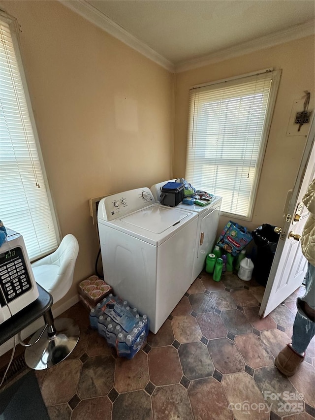 washroom with washer and dryer and crown molding