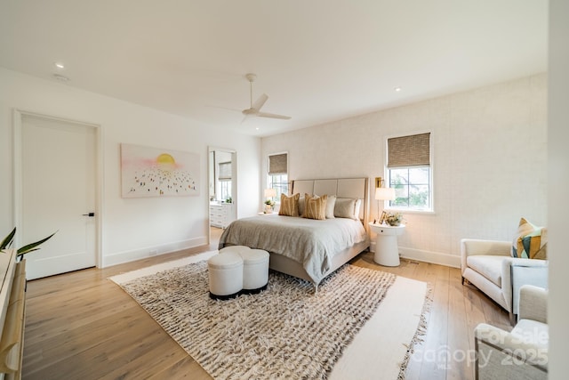 bedroom with ceiling fan and light hardwood / wood-style flooring