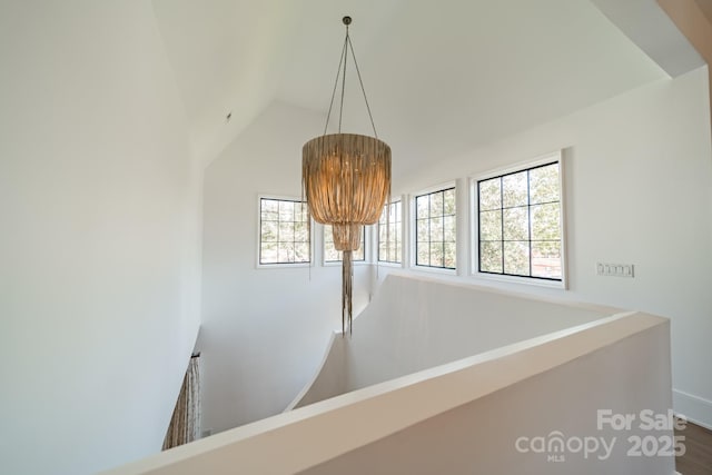 corridor featuring high vaulted ceiling