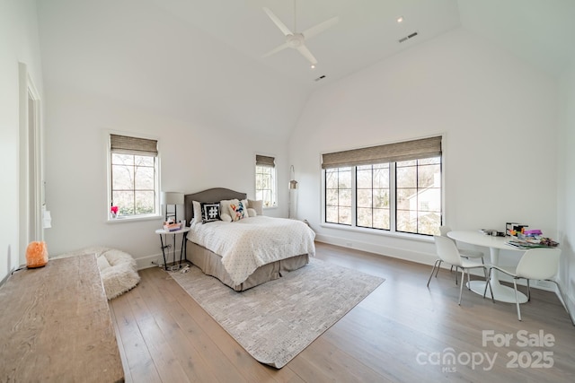 bedroom featuring ceiling fan, high vaulted ceiling, and light hardwood / wood-style flooring