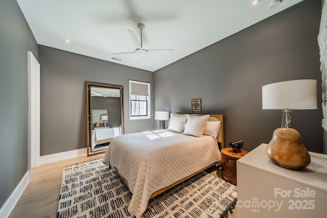 bedroom with ceiling fan and light hardwood / wood-style floors