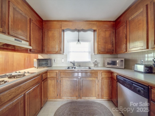 kitchen featuring light tile patterned floors, white appliances, sink, and hanging light fixtures