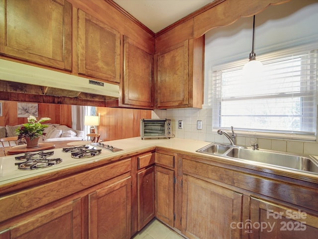 kitchen with sink, white gas stovetop, decorative light fixtures, decorative backsplash, and light tile patterned floors