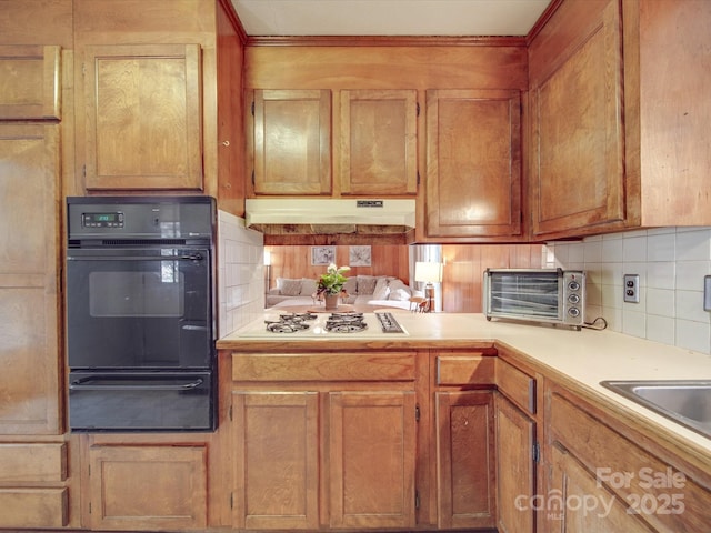 kitchen featuring backsplash and white gas cooktop