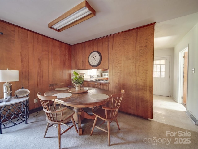 dining area featuring wood walls